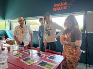 Lived experience group members voting for community projects using pebbles from eastbourne beach